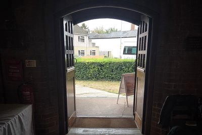 The open door of St Philip the Deacon church, Upper Stratton, seen from inside