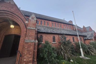 The red brick exterior of St Philip the Deacon church, Upper Stratton